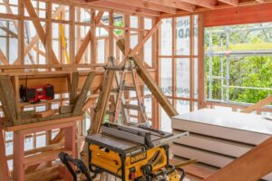 Timber framing and building materials inside a house under construction in Wellington