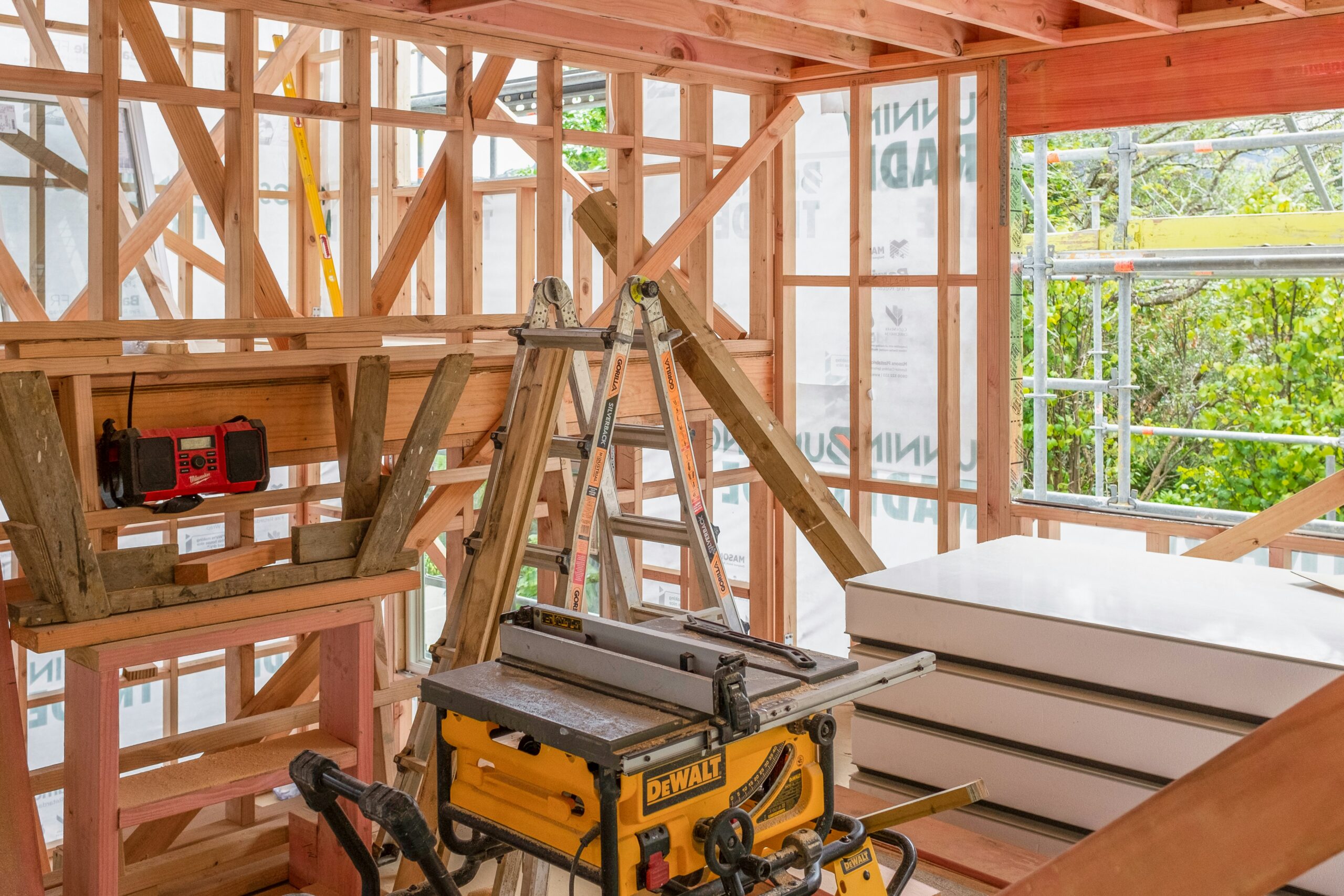 Timber framing and building materials inside a house under construction in Wellington