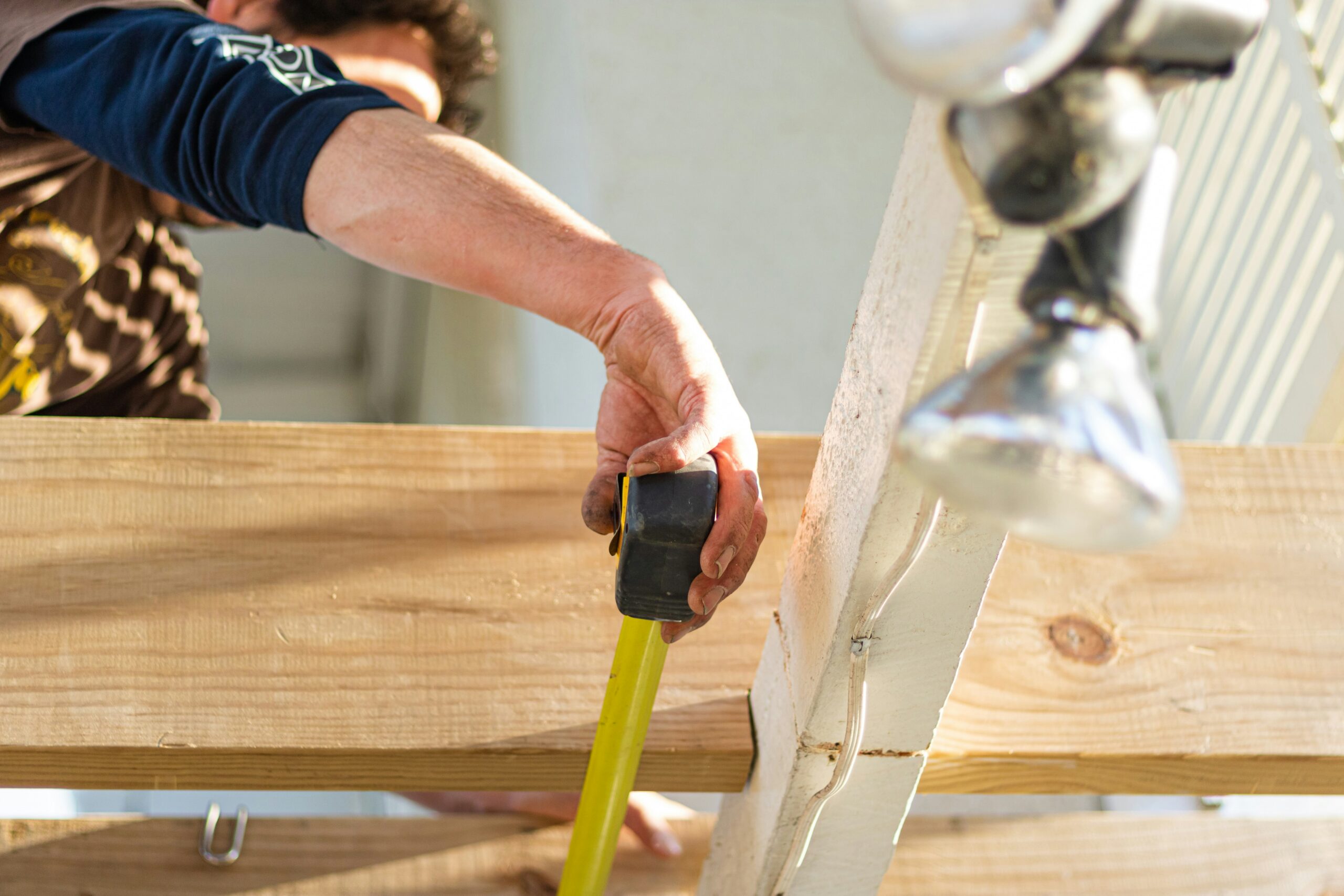 Builder measuring timber spacing